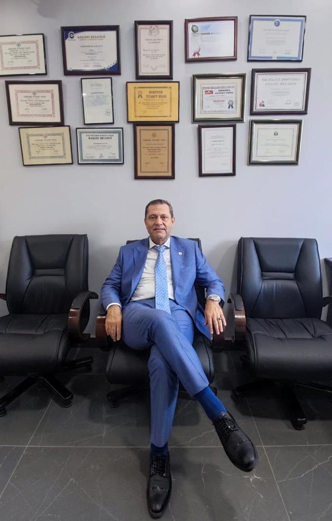 Berrah Celep in front of his certificates